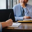 An interviewer checking a candidate’s resume