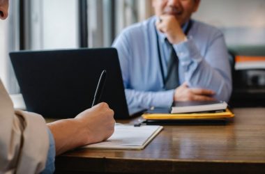 An interviewer checking a candidate’s resume